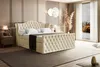 A bedroom scene featuring a large, upholstered bed. Produktbild-Vorschau