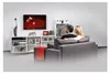 A couple is sitting on a sofa watching TV in a living room. Anteprima dell’immagine prodotto
