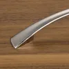 A close-up of a cabinet handle on a wooden surface. Produktbild-Vorschau