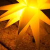 A close-up shot of a yellow star-shaped lamp, likely for outdoor decoration. Voir les images du produit
