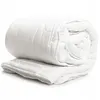 A white duvet rolled up and placed on a white surface. Produktbild-Vorschau