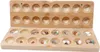 A wooden Mancala board game with colorful stones in its pits, shown open. Podgląd zdjęcia produktu