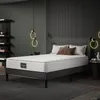 A bedroom scene with a mattress on a bed frame, bedside table, and shelving unit. Anteprima dell’immagine prodotto