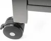 Close-up of a black caster wheel attached to a gray metal frame. Náhled obrázku produktu