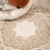 A close-up view of a textured rug with an abstract pattern. Voir les images du produit
