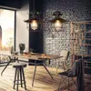 A dining room with industrial-style pendant lights, a wooden table, and brick walls. Produktbild-Vorschau