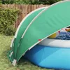A pool dome is set up over an inflatable pool in a backyard setting. Anteprima dell’immagine prodotto