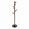 A wooden coat rack with a round base, photographed against a white background. Podgląd zdjęcia produktu