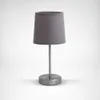 A modern table lamp with a gray fabric shade and a brushed metal base and stem, set against a plain background. Náhled obrázku produktu
