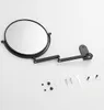 A black wall-mounted magnifying mirror with its accessories laid out below on a white background. Produktbild-Vorschau
