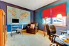 A home office with a large world map on the wall, a desk with a computer, and leather chairs. Anteprima dell’immagine prodotto
