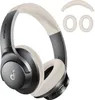 A pair of beige and gray over-ear headphones with extra ear pads and a headband cushion shown against a white background. Náhľad obrázku produktu