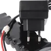 Close-up of a black power adapter with two prongs plugged into a black battery pack. Produktbild-Vorschau