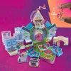 A collection of miniature toy houses and figures arranged in a playful, whimsical setting. Produktbild-Vorschau