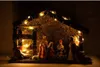 A nativity scene with figures and LED lights inside a stable. Produktbild-Vorschau
