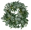A wreath made of green leaves, likely artificial, on a white background. Anteprima dell’immagine prodotto