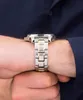 A close-up shot of a person's wrist wearing a silver and gold watch. Náhľad obrázku produktu