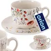 A set of porcelain cups and saucers with a floral pattern, presented on a white background with a product tag. Voir les images du produit