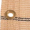 A close-up view of a beige shade cloth with a brass grommet. Produktbild-Vorschau