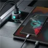 A car charger with multiple USB ports is shown plugged into a car's power outlet, charging a smartphone and a tablet. Produktbild-Vorschau