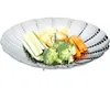 A stainless steel steamer basket filled with cut vegetables, including broccoli, carrots, zucchini, and potatoes. Produktbild-Vorschau