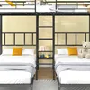 A bunk bed with two beds on the bottom level and two beds on the top level, with a ladder and shelf in between. Náhled obrázku produktu