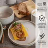 A table setting with a plate of food, bread, and a mug, accompanied by marketing text and icons. Produktbild-Vorschau