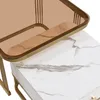 A close-up view of two nesting tables, one with a marble-look top and the other with a tinted glass top and gold frame. Náhľad obrázku produktu