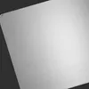 A close-up, angled view of a silver cutting board with a brushed metal finish, set against a dark background. Produktbild-Vorschau