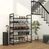 A shoe rack filled with shoes is placed next to a staircase and an umbrella stand. A plant is also visible in the scene. Produktbild-Vorschau