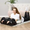 A woman is lying on the floor next to a massage roller, using it on her hands. Náhľad obrázku produktu