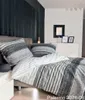 A bedroom scene with a bed dressed in patterned bedding. Produktbild-Vorschau
