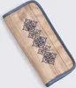 A close-up, angled view of a fabric case with blue trim and embroidered blue floral patterns. Produktbild-Vorschau