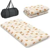 A black duffel bag and a folded padded mat with a bear pattern are shown against a white background. Produktbild-Vorschau