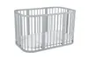 A gray crib with a white mattress inside, set against a white background. Produktbild-Vorschau