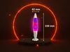 A lava lamp is displayed on a dark circular platform with a glowing orange ring behind it. Náhľad obrázku produktu