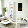 A tall white bookshelf filled with decorative items and books, placed in a modern living room next to a sofa and coffee table. Produktbild-Vorschau