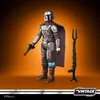 A Star Wars Vintage Collection The Mandalorian Beskar action figure with accessories against an orange and brown gradient background. Produktbild-Vorschau