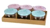 A set of six glass jars with decorative lids, presented in a cardboard tray. Anteprima dell’immagine prodotto