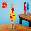 Three lava lamps are displayed on a wooden table against a light blue background. The lamp in the foreground is yellow with red blobs, and has 'TAKE IT EASY' text on its base. Two other lamps are visible in the background, one with a rainbow effect and ano Anteprima dell’immagine prodotto