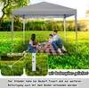 A family having a picnic under a gray pop-up canopy in a grassy park. Voir les images du produit