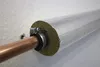 A close-up view of insulated copper pipe attached to a wall. Produktbild-Vorschau