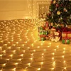 Christmas tree with gifts and lights on a wooden floor. Náhled obrázku produktu