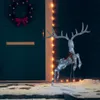A lighted reindeer decoration stands on a snowy porch next to a dark blue door decorated with a Christmas wreath. Produktbild-Vorschau
