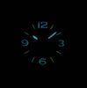 A close-up of a watch face with glowing blue numbers and hands against a black background. Produktbild-Vorschau