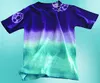 A tie-dyed t-shirt with a gradient of purple to turquoise, displayed against a light blue background. Produktbild-Vorschau