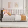 A tufted beige daybed with LED lighting and a yellow throw blanket is shown in a bedroom setting. Podgląd zdjęcia produktu