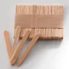 A stack of wooden popsicle sticks bound by a paper band, with four individual sticks laid out in front. Produktbild-Vorschau