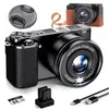 A product shot of a digital camera and its accessories, including a lens cap, camera strap, batteries, memory card, and charging cables, arranged around the camera. Podgląd zdjęcia produktu