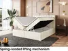 A bedroom scene featuring a bed with its storage compartment open, showcasing the lifting mechanism. The room is decorated with modern furniture and artwork. Produktbild-Vorschau